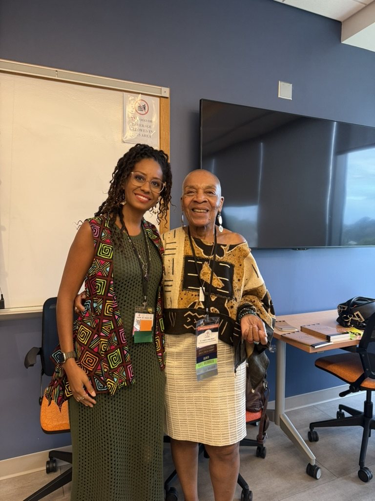 Cheyennis Doom and Linda James Myers, Ph.D. in a classroom, wearing name badges, at the ABPsi Convention
